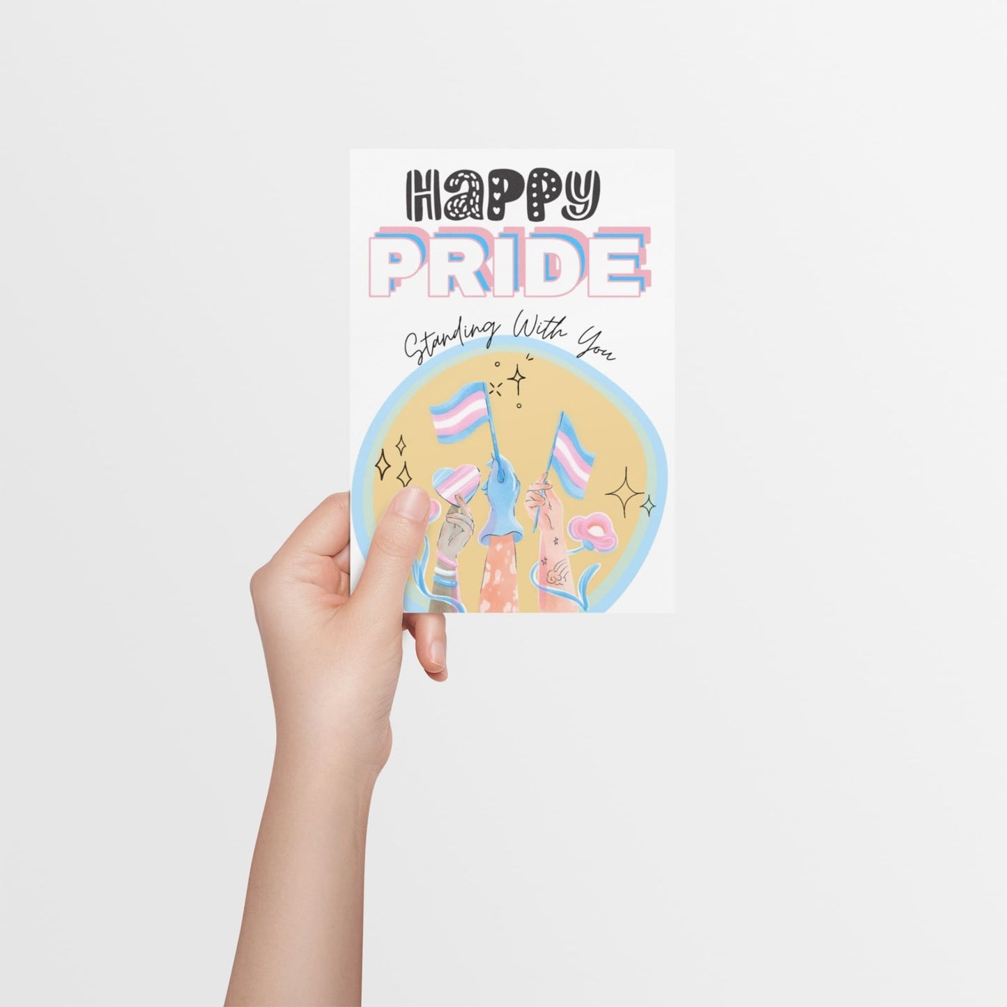 A card, with big bold font saying 'Happy Pride' in Transgender flag colours and a large Transgender flag in the centre of the card. Designed to support transgender people during Pride and show allyship.