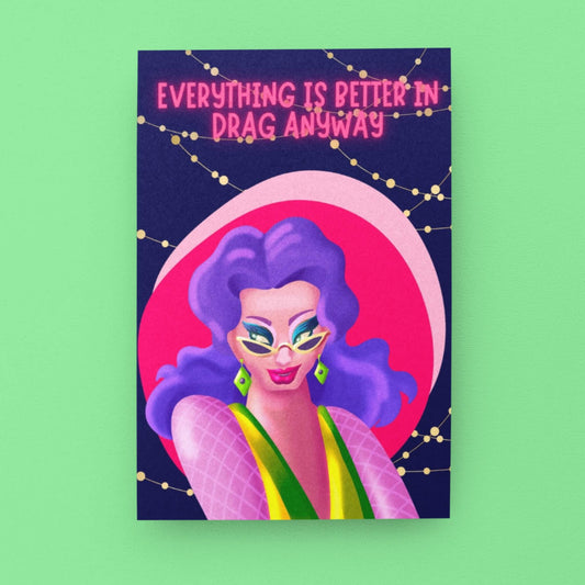 A card, with a dark blue background and fairy lights featuring a drag queen dressed in bright colours in a sassy pose. Designed to support and celebrate drag artists. 